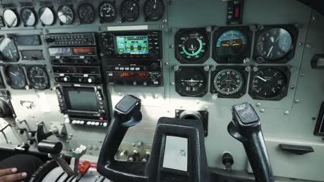 cessna aircraft cockpit interior pan across instrument panel and pilot controls moving during flight