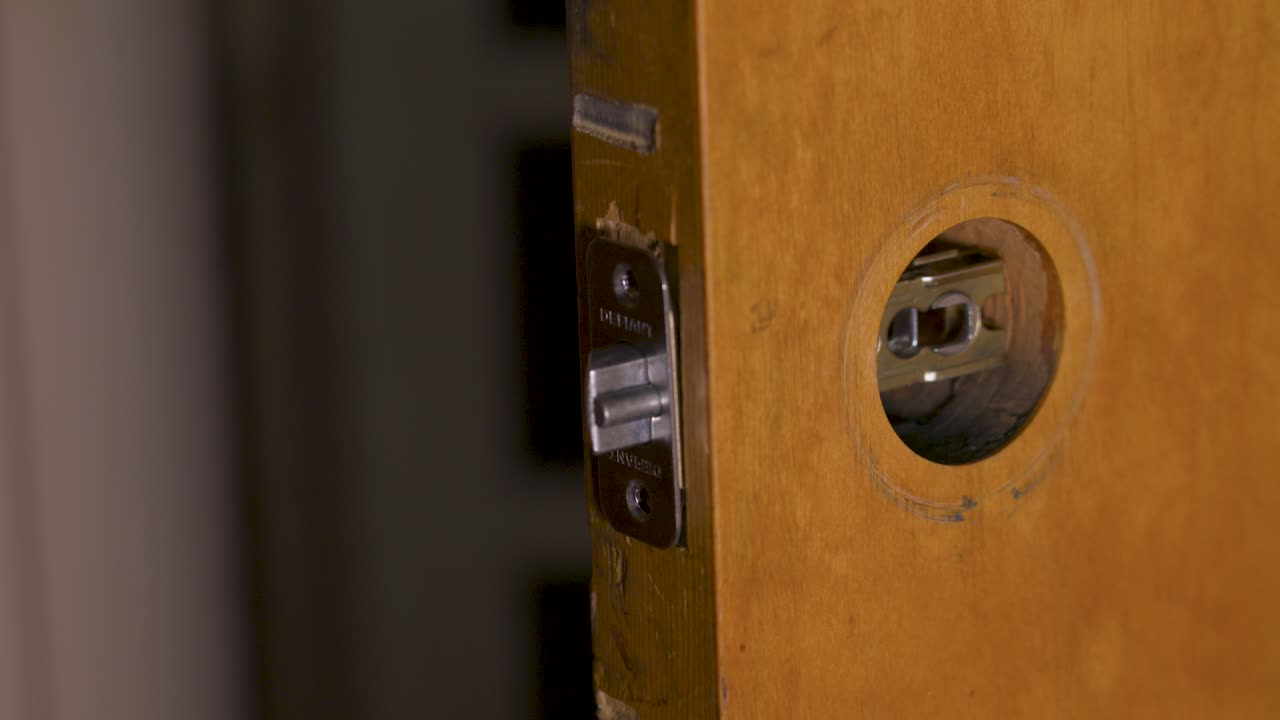 Securing the top anchor screw into the door