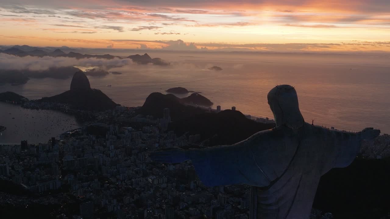 Aerial drone above the Christ the Redeemer during epic sunset statue of Jesus in Rio de Janeiro, Brazil