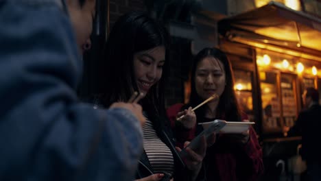 friends enjoying street food at night