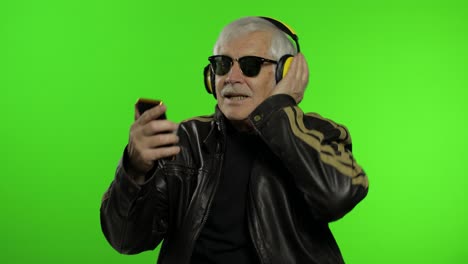 Elderly-caucasian-grandfather-biker-man-dance,-listen-music.-Chroma-key