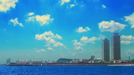 clouds over skyscrapers on sea coast. timelapse of white clouds over blue sea