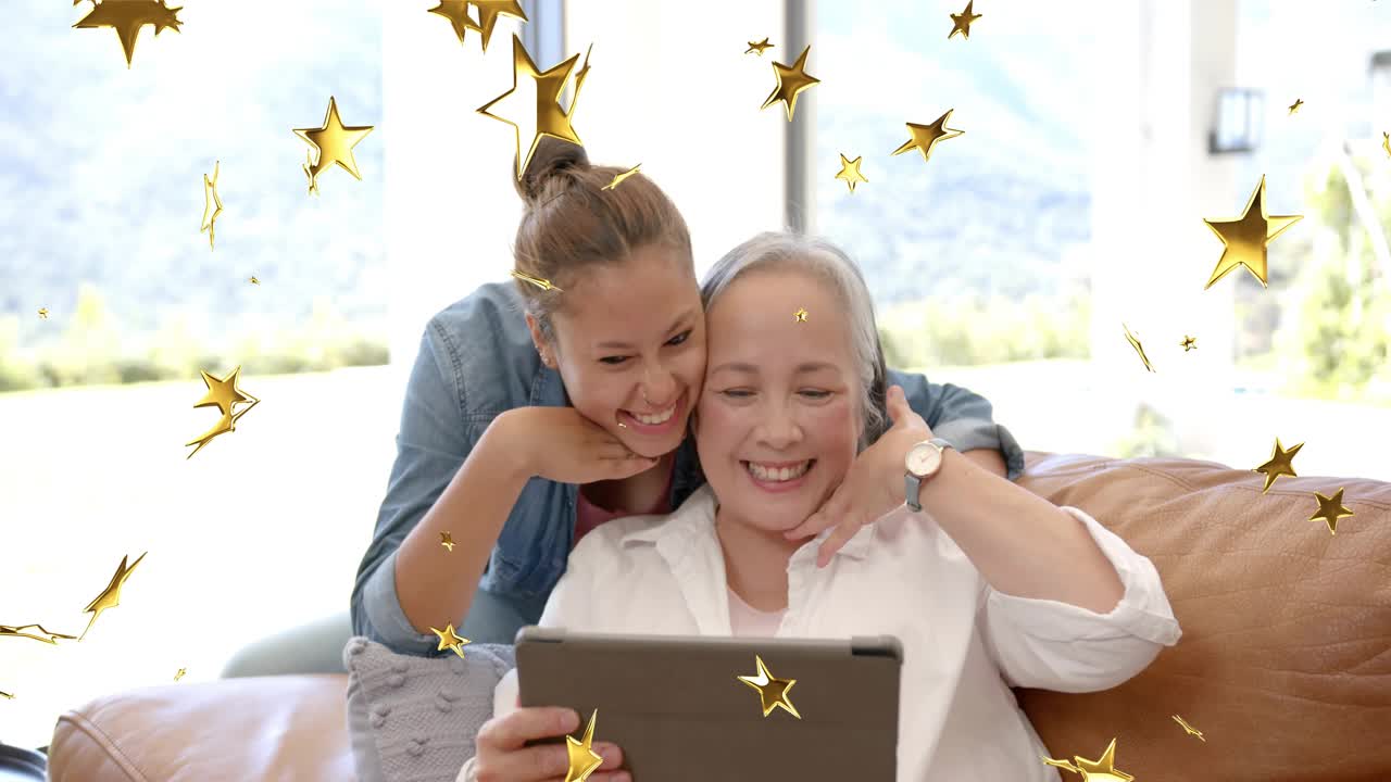 Mature woman tapping tablet, teen leaning over, creating gold stars and sharing tech family joy