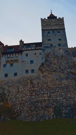 beautiful castle bran the concealment on vicious count dracula. low angle view of the historic building in autumn nature. vertical video