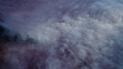 dense clouds of smoke from a smoke machine creating a dramatic effect at an event