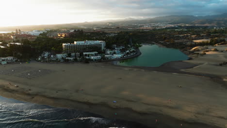 maspalomas dunes, gran canaria: aerial view in orbit of the maspalomas pond during sunset
