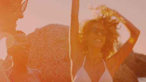 Group-of-diverse-friends-dancing-and-enjoying-at-the-beach