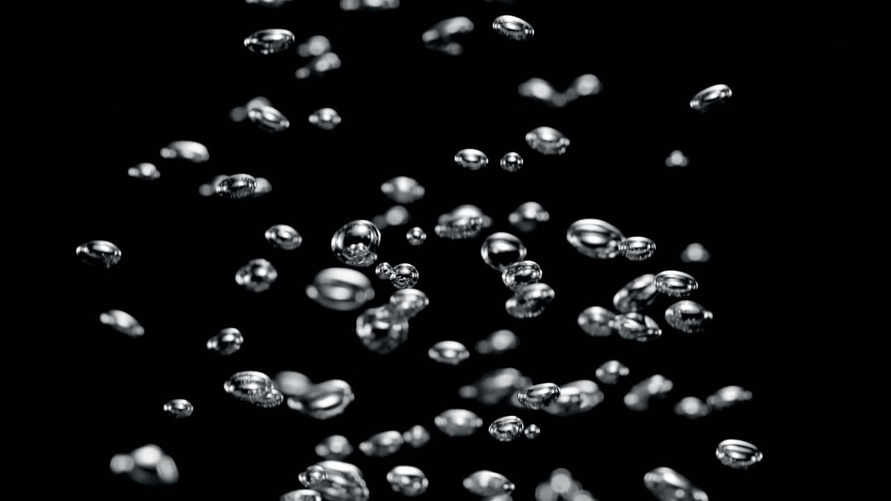 Small Air Bubbles Rise From The Bottom Up In The Black Water Depths in Macro and Slow Motion, Side View