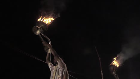 indian men holding up ceremonial candles