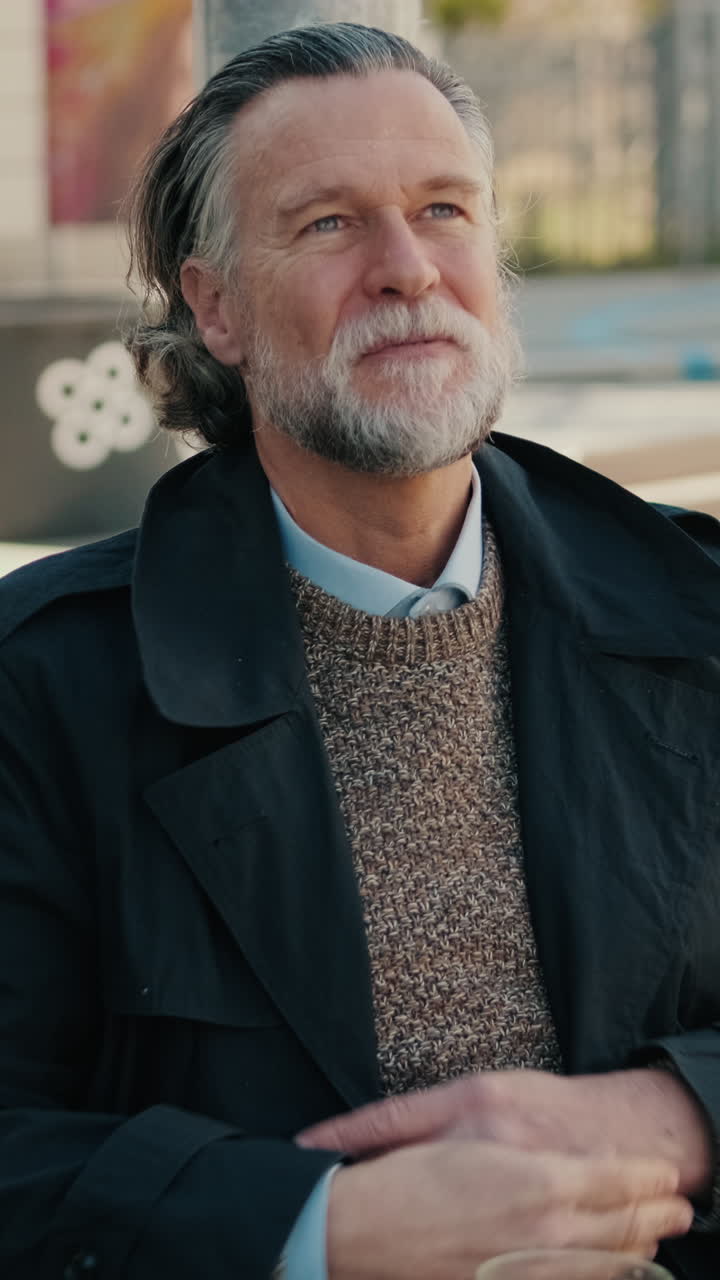 Contemplative Senior Man in an Outdoor Cafe