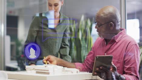 Animation-of-profile-icons-over-diverse-man-and-woman-discussing-over-a-plan-model-at-office