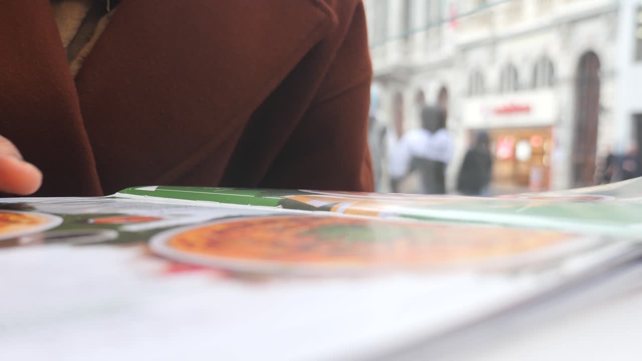 mujer leyendo un menú en una cafetería