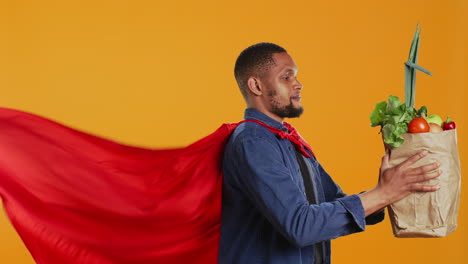 African-american-guy-posing-as-a-superhero-with-fresh-ripe-produce