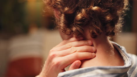 close-up of a person's neck and hand