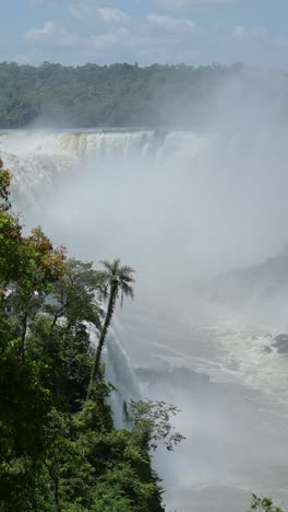 brazil iguazu falls waterfalls scenery, iguacu falls tropical rainforest landscape vertical video for social media instagram reels and tiktok, beautiful big massive powerful waterfall in brazil