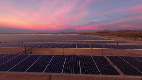 dpv drone flying over solar panels in a desert solar farm at golden hour