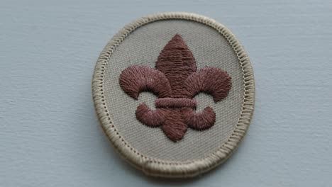 close up pan right of a boy scout arm patch