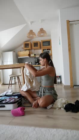 woman packing clothes for a trip