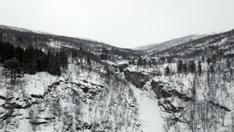 Drone-flying-over-snowy-landscape-in-Norway