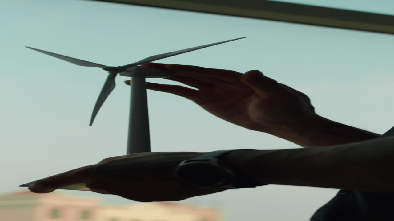 Hands of Ecologist Holding Mockup of Wind Turbine