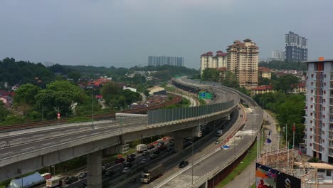 Toma-Aérea-De-Elevación-De-Drones-Que-Captura-La-Autopista-E37-Salak-Y-El-Tráfico-Del-Paso-Subterráneo-Con-Un-Horizonte-Brumoso-En-La-Ciudad-De-Kuala-Lumpur,-Malasia,-Sudeste-De-Asia