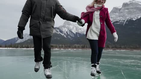 couple skating together on a frozen lake