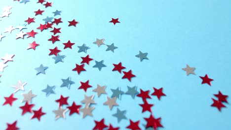 Red-and-blue-stars-lying-on-blue-background-with-copy-space