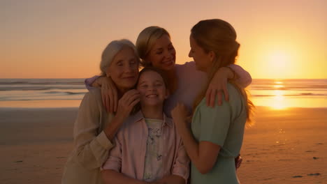 a multigenerational family embracing on a beach at sunset
