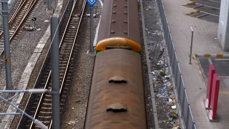 A-multi-car-train-running-on-a-railroad-viewed-in-high-angle-showing-train's-roof