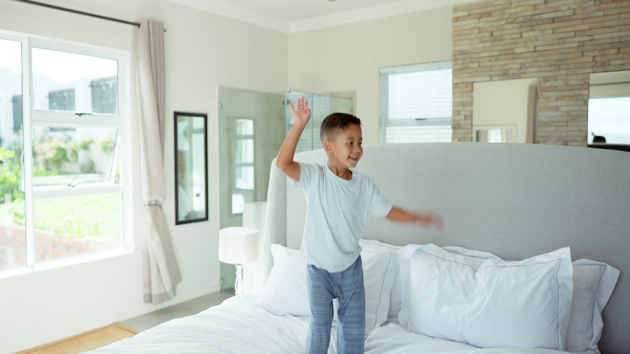 Fun, happiness and child jumping on bed