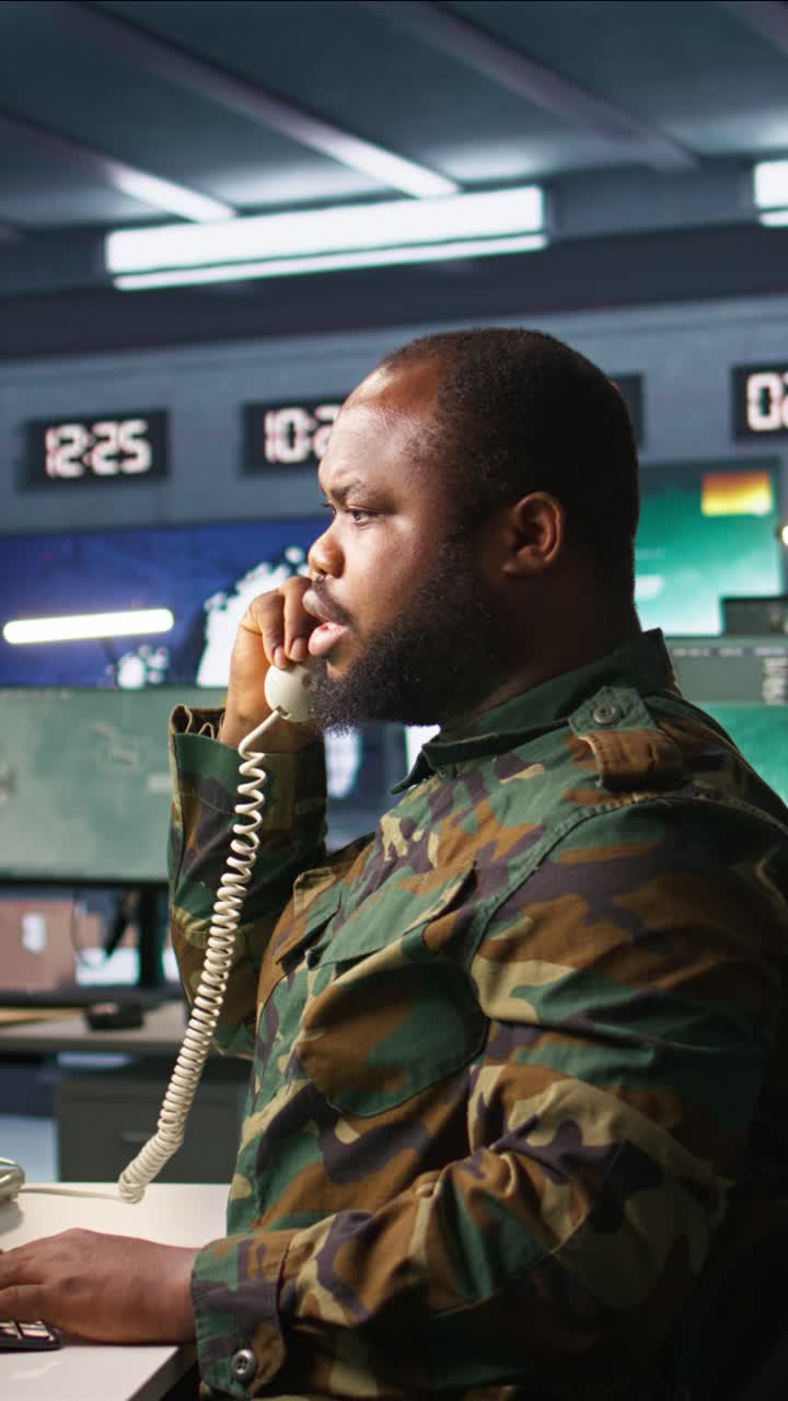 Vertical video Military officer making telephone call to relay enemy info