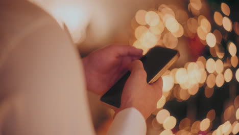 hand using smartphone at home during christmas