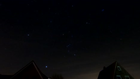star time lapse of the night sky moving, above a house, at midnight
