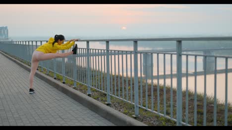woman stretching outdoors at sunrise