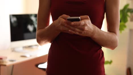 caucasian woman using her phone at home