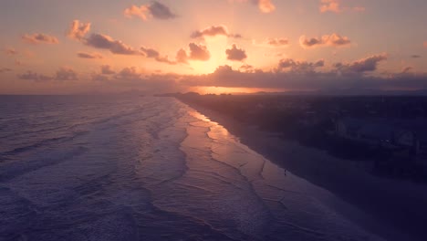 tilting drone shot revealing dramatic sky over brazilian beach city itanhaem