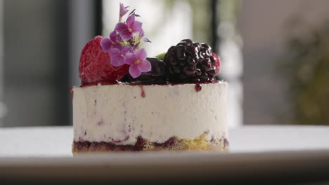 final touches on ice cream cake with berries