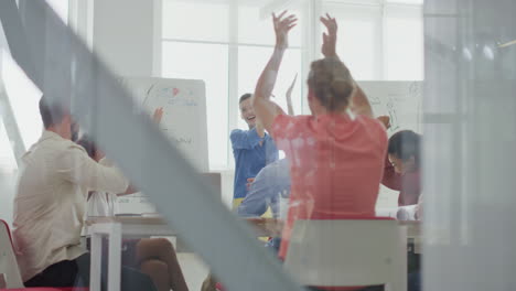 through glass people applauding office. successful colleagues celebrating.