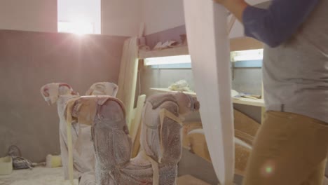 male surfboard maker in his workshop