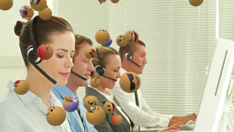 Animation-of-emoji-falling-over-business-people-wearing-phone-headsets