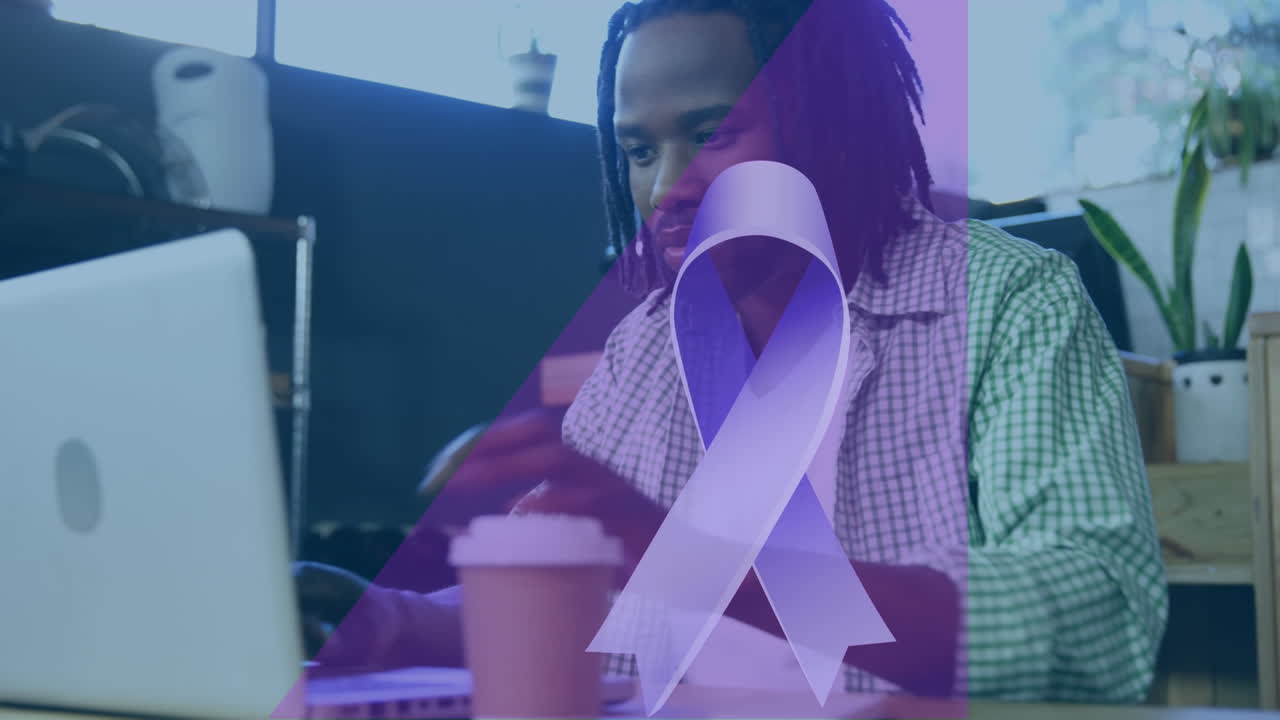 Animation of blue ribbon icon over african american man drinking coffee and using laptop at a cafe
