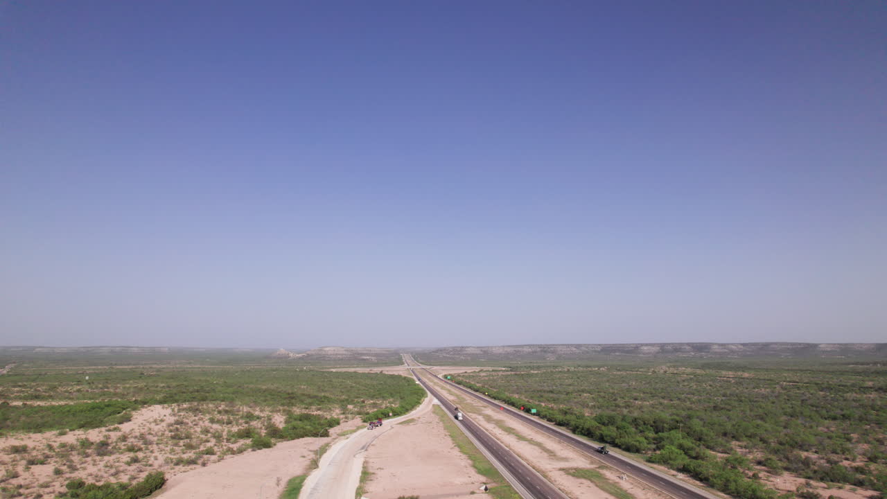 High angle of 18 wheelers driving on I-10 in the West Texas desert