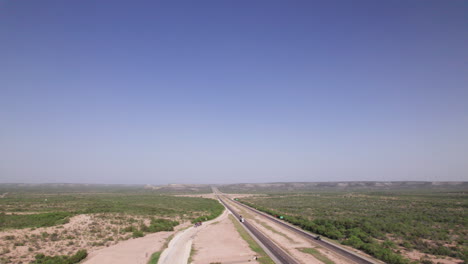 high angle of 18 wheelers driving on i-10 in the west texas desert