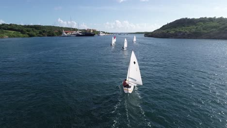 drone flying over sailboats sailing on the open water ocean caribbean