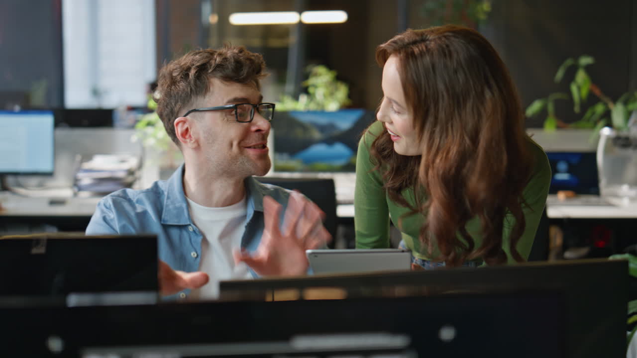 Focused colleagues looking monitor discussing business results in agency closeup