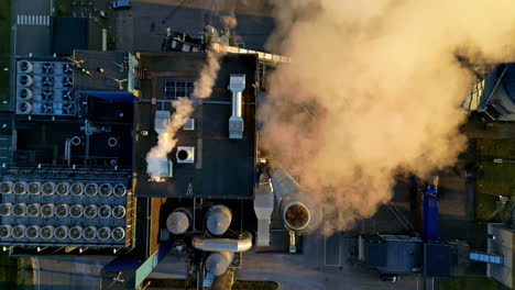 Industrial-factory-with-smoking-chimneys,-aerial-top-down-view