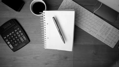 fountain pen and notepad falling on office desk