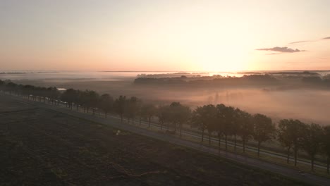 misty sunrise over country road