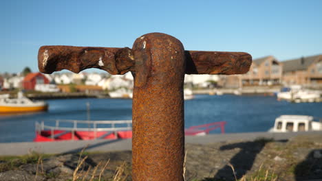 static shot, of a rusty, old cleat point, boat dock, at a pier, on a sunny and windy day, in lista, norway