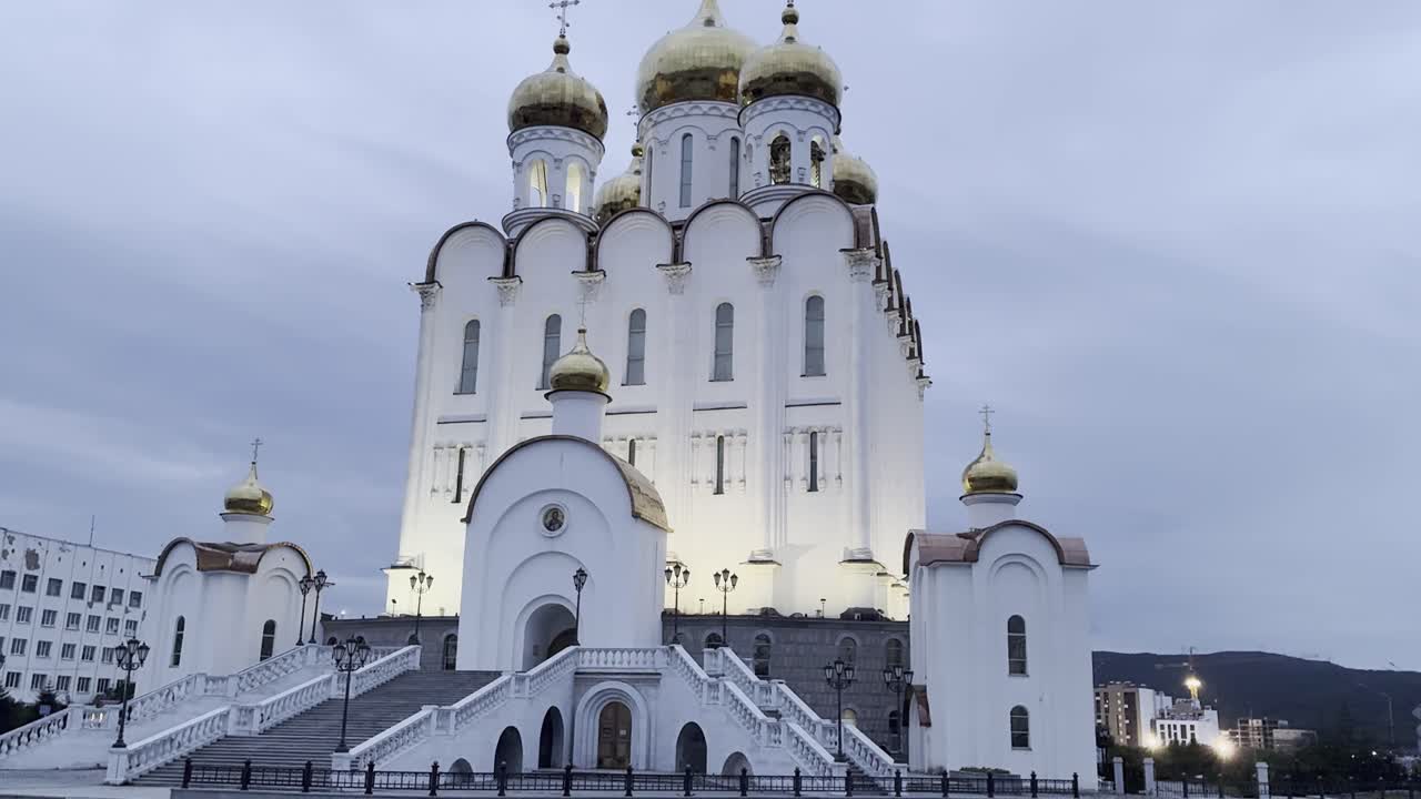 Illuminated cathedral stands majestically against a cloudy sky